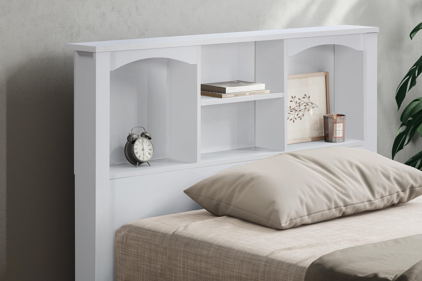 White bookshelf bed with bedding, clock, and decor items against a gray wall.